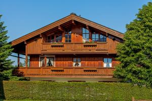 duży drewniany dom z dużym balkonem w obiekcie Chalet Weißlofer w mieście Reit im Winkl