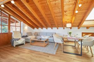 a living room with a couch and a table at Chalet Weißlofer in Reit im Winkl