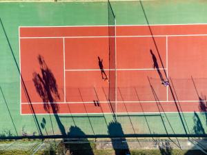 un grupo de personas de pie en una pista de tenis en Hotel Mira, en Peschici