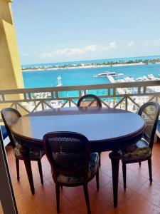 a table on a balcony with a view of the ocean at Porto Marina Rental in El Alamein