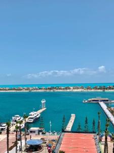 a view of a harbor with a boat in the water at Porto Marina Rental in El Alamein