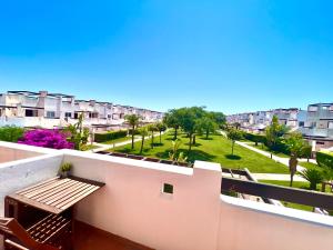 a balcony with a table and chairs and apartments at Condado de Alhama NARANJOS 7 SV12 in El Romero