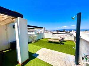 a small balcony with green grass on the roof at Condado de Alhama NARANJOS 7 SV12 in El Romero +10 photos