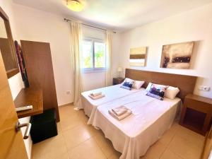 a bedroom with two beds and a window at Condado de Alhama NARANJOS 7 SV12 in El Romero