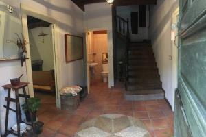 a hallway of a house with a staircase and a bathroom at La Naranxa in Bárzana