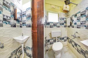 a bathroom with a toilet and a sink at Hotel O Maa Residency Near Biswa Bangla in Thākurdwari