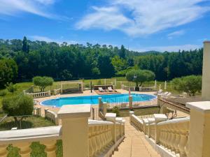 a view of a pool from the balcony of a house at LES TERRASSES DE VALERIAN in Brignoles