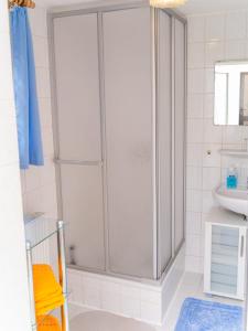 a shower with a glass door in a bathroom at Ferienwohnungen Christine Knoll in Bad Frankenhausen
