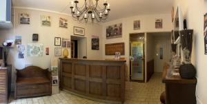 a shop with a cash counter and a chandelier at Hotel du Lion d'Or in Rocamadour