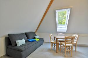 a living room with a couch and a table at Ferienwohnungen und Ferienzimmer Haus Waldblick Trusetal in Brotterode-Trusetal