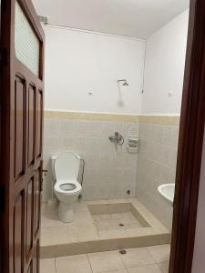 a bathroom with a toilet and a tub and a sink at Calairis House in Asilah