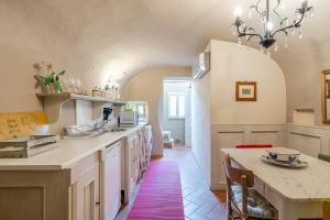 a kitchen with a table and a counter top at Residenza Gatteschi in Pistoia