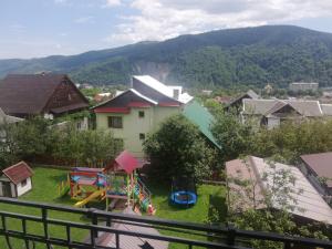 a small yard with a playground in a house at Садиба АнноМарі - відпочинок в Карпатах котедж Яремче in Yaremche