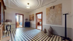 a room with a checkered floor and a painting on the wall at Architectural gem with vintage charm in La Chaux-de-Fonds