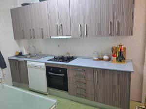 a kitchen with a sink and a stove top oven at Genial casa en centro in Ceuta