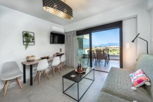 a living room with a couch and a table at Katerina Luxurious Sea View in Nikiana