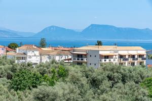 a group of buildings on a hill with the water at Katerina Luxurious Sea View in Nikiana