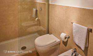 a bathroom with a toilet and a shower and a sink at Albergo Diffuso Birkin Castello in Cagliari