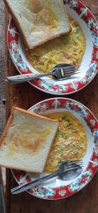 two plates of food on a table with toast at Tetebatu Fullmoon in Tetebatu