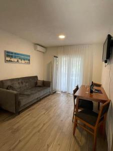 a living room with a couch and a table at Villa Ornella in Nečujam