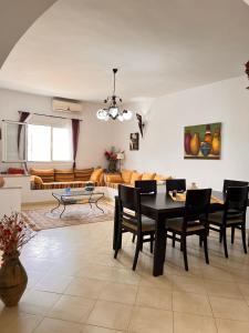 a living room with a black table and chairs at Villa Elena in Midoun