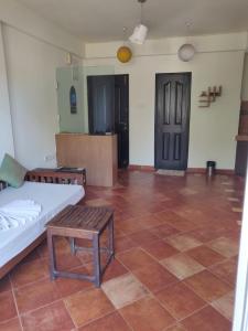 Habitación con cama, mesa y suelo de baldosa. en AQUAVISTA at CasaPhilomena en Calangute