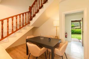 a dining room with a black table and chairs at Villa Vacacional Toró Playa in Llanes +38 photos