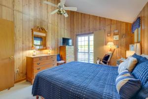 - une chambre avec un lit bleu et des murs en bois dans l'établissement Provincetown Home with Stunning Views!, à Provincetown