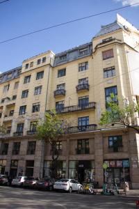 a large building with cars parked in front of it at Luxury Downtown 3 Bedroom Apartment by Synagoge with Beautiful View in Budapest