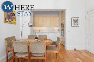 a kitchen and dining room with a table and chairs at Lovely 3 Bedroom apartment Easter Road in Edinburgh