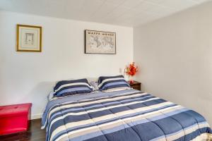 Schlafzimmer mit einem Bett mit blauen und weißen Streifen in der Unterkunft Cozy Berkshires Vacation Rental Near Hiking! in Chester