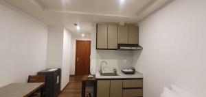 a small kitchen with a sink and a microwave at JCGA Apartments at Megatower Residences IV - Near SM & Session Rd in Baguio