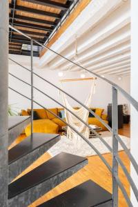 a staircase leading to a living room with yellow furniture at Le Loft du Vieux-Port - St Victor in Marseille