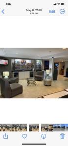 a living room with two couches and a tv at Travelodge Inn & Suites by Wyndham Albany in Albany