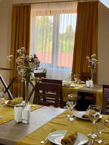 a dining room with tables and chairs and a window at УЗВАР in Bobrka