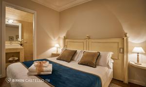 a bedroom with a bed with a towel on it at Albergo Diffuso Birkin Castello in Cagliari