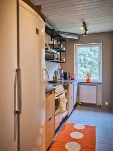 a kitchen with a refrigerator and a window at Herrestad Bed & Guestroom in Värnamo