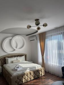 a bedroom with a bed and a ceiling at Hotel Panorama in Gjakove