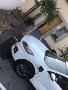 una macchina bianca parcheggiata di fronte a una casa di Hôtel Center Saint-Quentin a Saint-Quentin