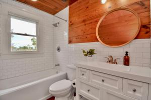 a bathroom with a sink toilet and a mirror at Coastal Craftsman- Walk to Beach & Pleasure Pier- As seen on 'Restoring Galveston' in Galveston +20 photos