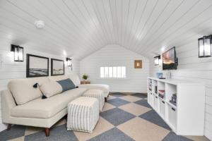 a living room with a couch and a tv at Coastal Craftsman- Walk to Beach & Pleasure Pier- As seen on 'Restoring Galveston' in Galveston