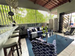 a living room with a blue couch and chairs at Casa Sophia 3 listings Apartment 1 or Apartment 2 separately or Apt 1 and 2 together all with FO internet in Guápiles