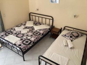Postel nebo postele na pokoji v ubytování Polyxenis Rooms