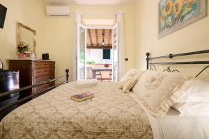 a bedroom with a bed with a book on it at La Casa di Lisa in San Vincenzo
