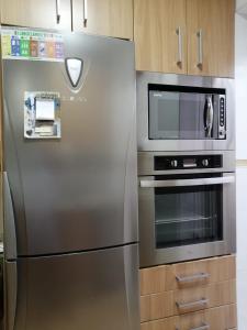 a stainless steel refrigerator and microwave in a kitchen at Piso en San Fernando (Cádiz) in San Fernando