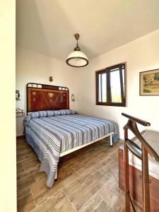a bedroom with a large bed with a wooden headboard at Agriturismo il Pianetto in Principina Terra