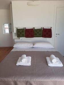 a bedroom with a bed with two towels on it at loft giulia in Bari
