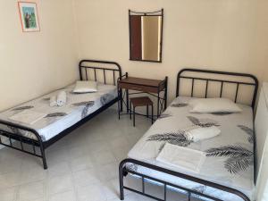 Postel nebo postele na pokoji v ubytování Polyxenis Rooms