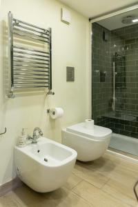 a bathroom with a sink and a toilet and a shower at Poseidon's Creek - Luxury Apartment in Naples