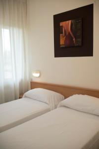 Postel nebo postele na pokoji v ubytování Albergo Aurora